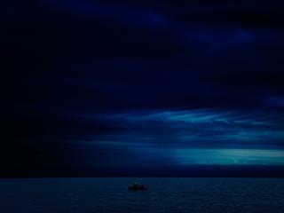 Dark Evening Blue Cloudy Alone Boat In Ocean wallpaper