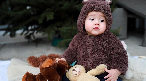 Cute Baby In Brown Woolen with Toys Wallpaper 1440x2960 Resolution