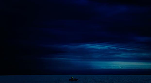 Dark Evening Blue Cloudy Alone Boat In Ocean Wallpaper