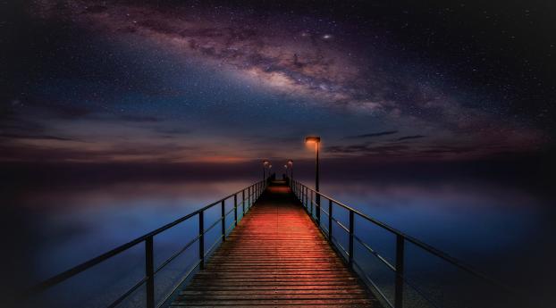 Ocean Pier under Milky Way Sky Wallpaper 1366x768 Resolution