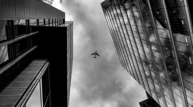 Plane Between Two Buildings Monochrome Wallpaper 480x960 Resolution