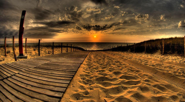Sand And Pathway To Sea Under Cloudy Sunset Wallpaper 1242x268 Resolution